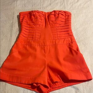 Bebe Strapless Orange Romper with Pockets